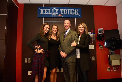 (l. to r.) Camryn, Erin, Jim and Jill Kelly pose below sign in "Kelly Tough Room" at ECMC.