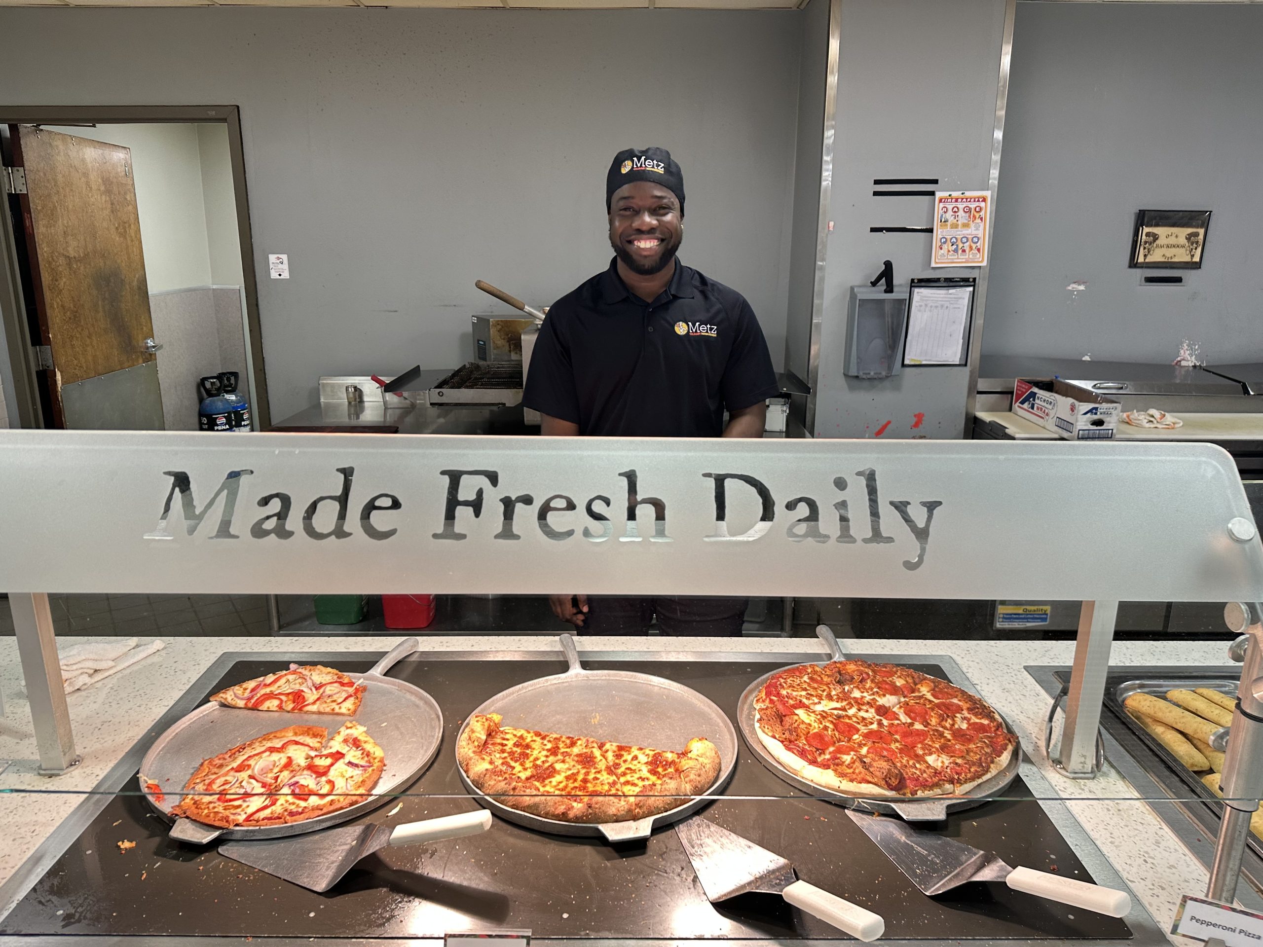 Chef Jermel “OJ” Morrison posing with Pizza